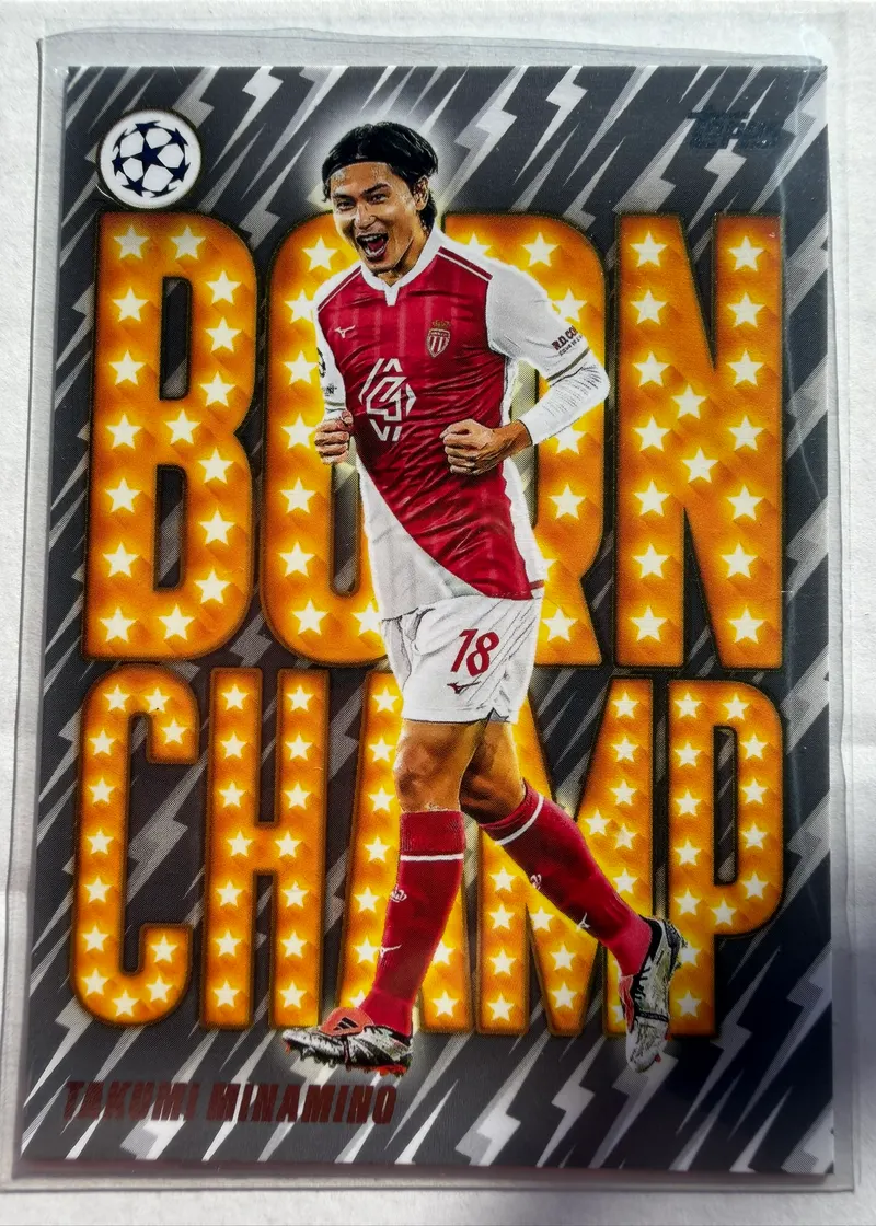 Takumi Minamino, Topps UEFA Club Competitions 2025/26 Born Champ, karta BC-12 — awers z wielkim żółtym napisem BORN CHAMP w gwiazdki i piłkarzem w stroju Monaco