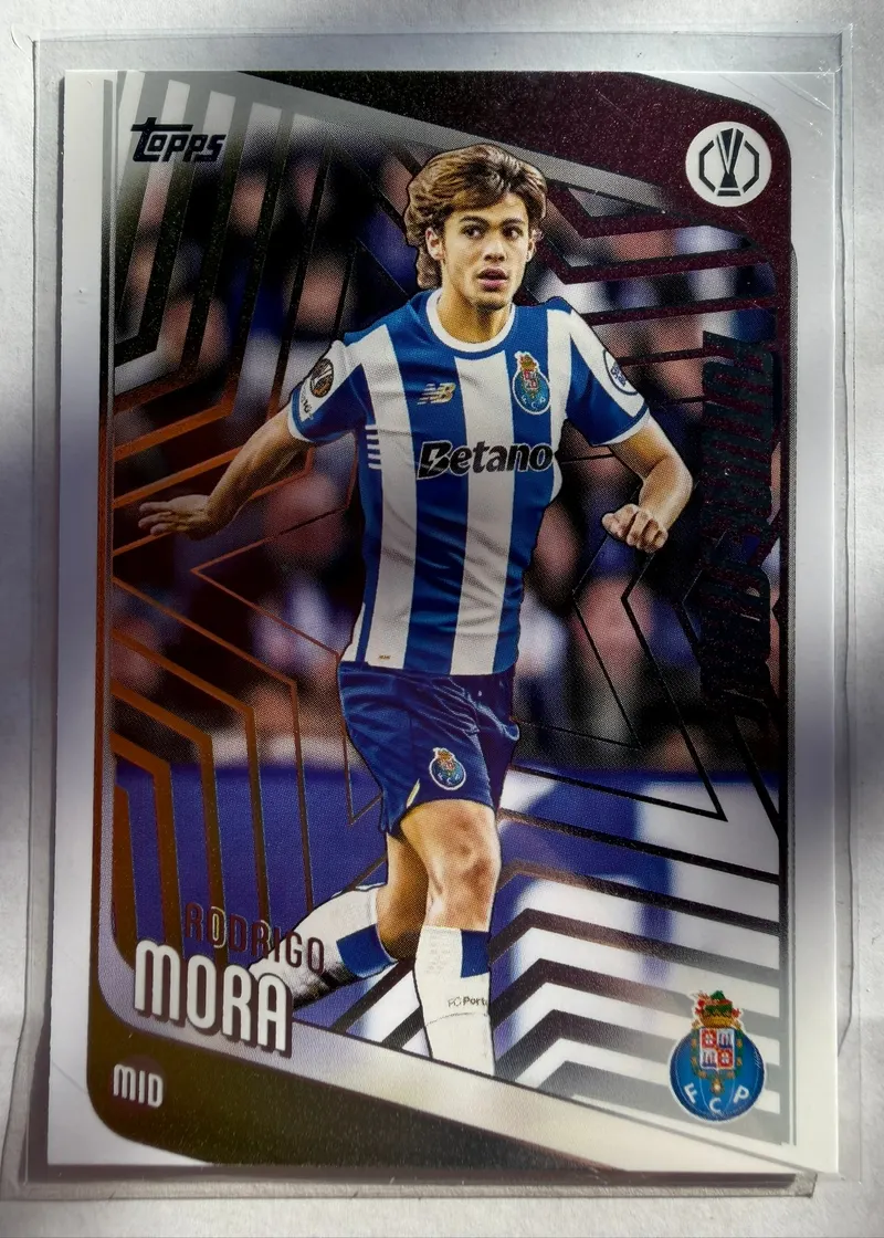 Rodrigo Mora, Topps UEFA Club Competitions 2025/26, karta 83 — awers z zawodnikiem w niebiesko-białych pasach FC Porto na tle geometrycznego wzoru