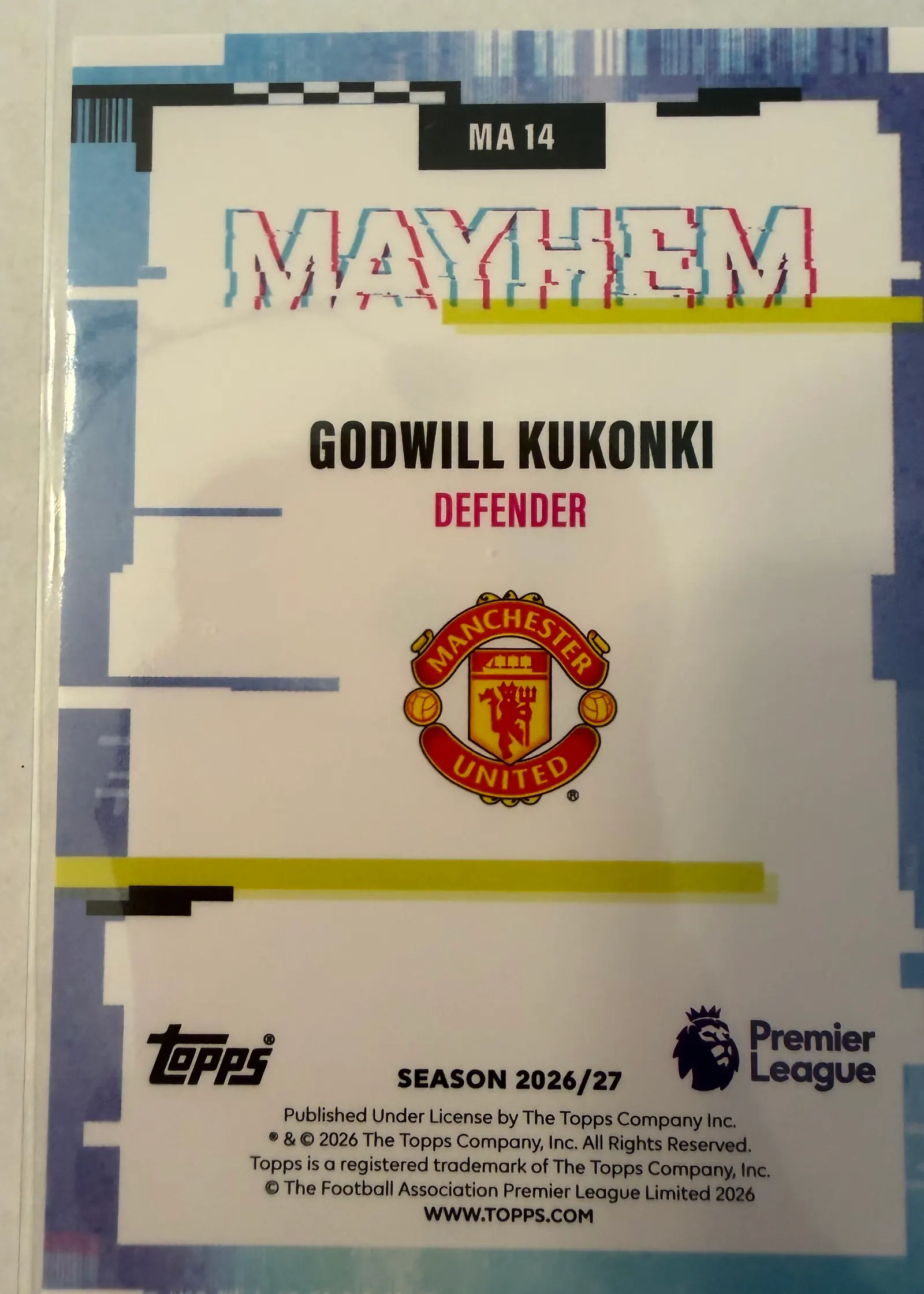 Godwill Kukonki, Topps Premier League 2026/27 Mayhem MA 14 — rewers z herbem Manchesteru United i numerem MA 14